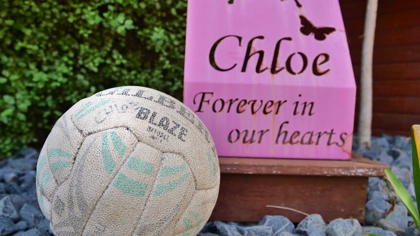 Chloe Myors' netball in front of a sign that says Chloe Forever in our hearts.