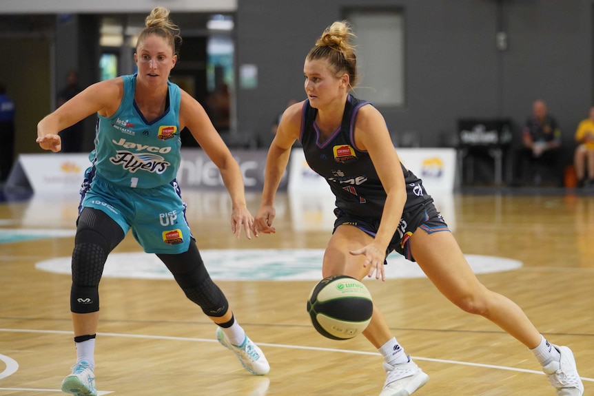 A Townsville Fire WNBL player dribbles the ball with her left hand against Southside Flyers.