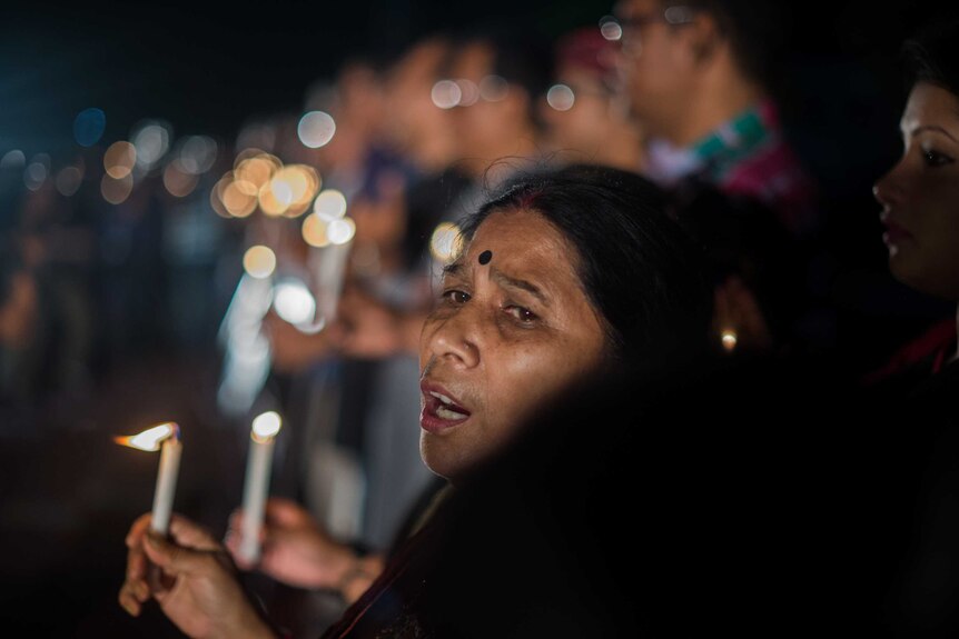 Bangladeshi woman holds candle