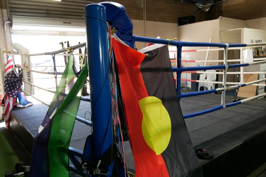 An empty boxing ring, decorated with the Aboriginal and Torres Strait Islander flags