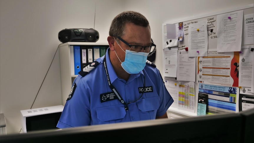 a police officer at a computer