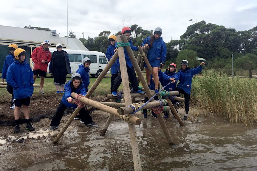 Students working in a bridge building exercise.