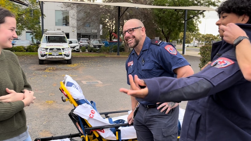 Paramedic smiles at student