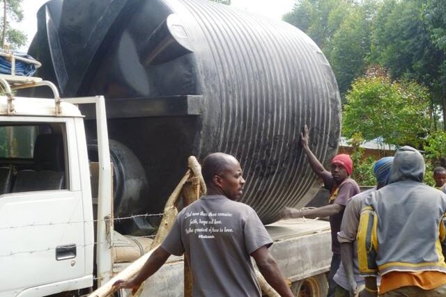 Water tank being delivered in African village