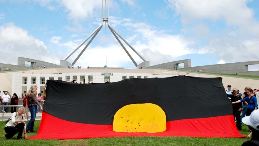 A large Aboriginal flag on the lawns of Parliament House