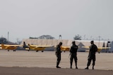 Soldiers chat as they keep watch at Palmerola Air Base in Honduras.
