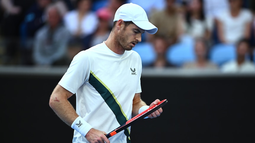 A British male tennis player looks at his racquet during a match at the Australian Open.