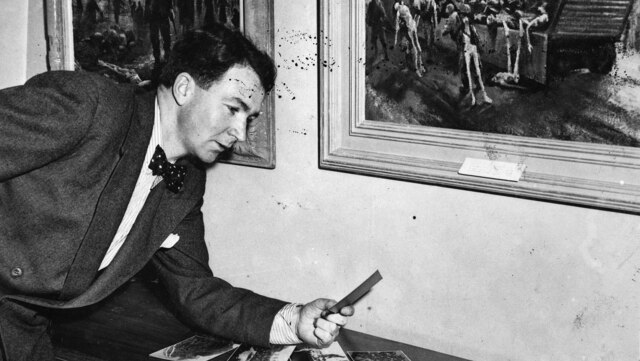 Former war artist Alan Moore at an exhibition of his Belsen paintings in 1947.