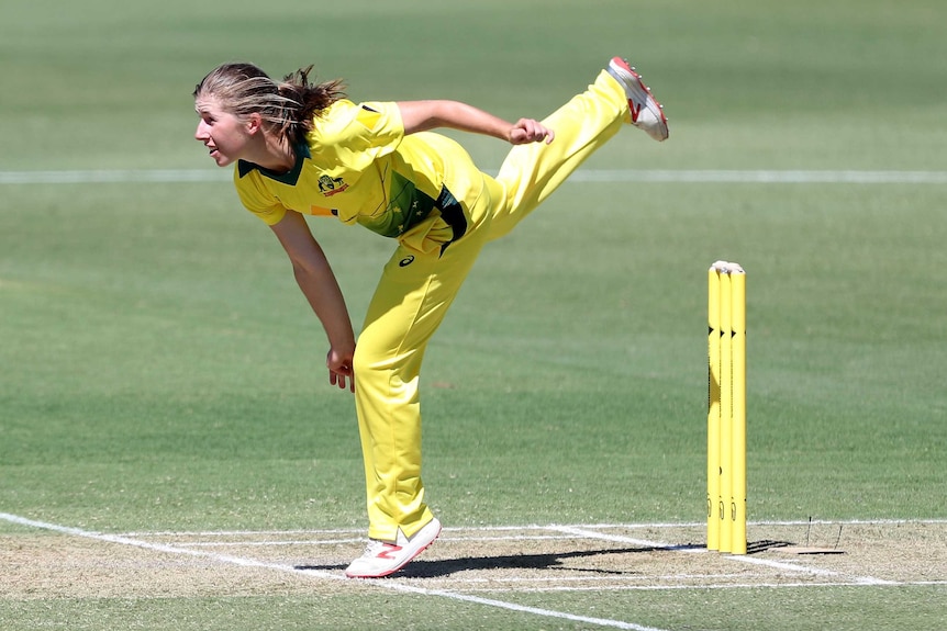 Georgia Wareham with her left foot on the bowling crease after she bowls a delivery for Australia against New Zealand.