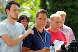 Don Damond is comforted by his son Zach Damond as he speaks to the media about his fiance