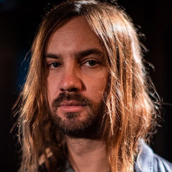 Kevin Parker of Australian band Tame Impala looks at the camera in a close-up portrait.