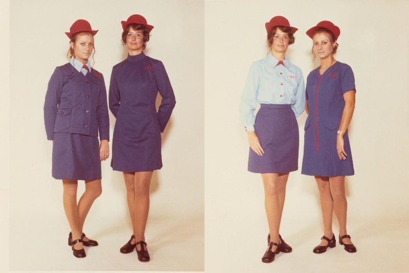 Two women side by side wearing a blue uniform with red hats, one for winter and one for summer