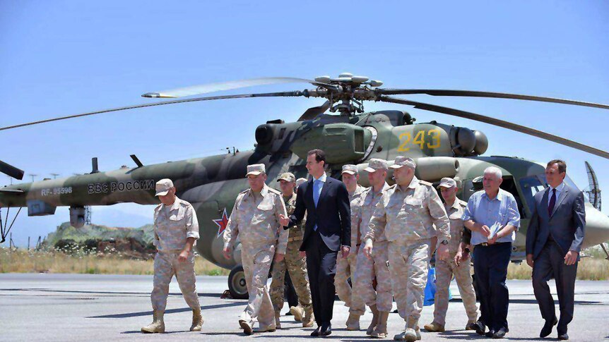 Syrian President Bashar Assad inspects the Russian Hemeimeem air base