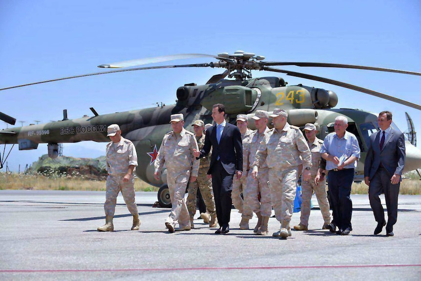 Syrian President Bashar Assad inspects the Russian Hemeimeem air base