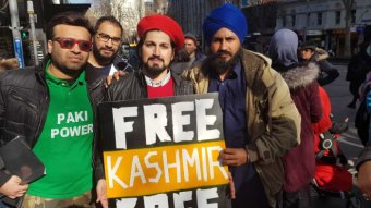 Activists hold a sign called "Free Kashmir Free".