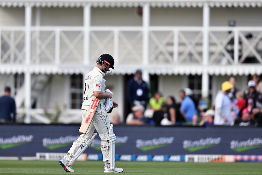 Kane Williamson's had is dropped as he walks off the field