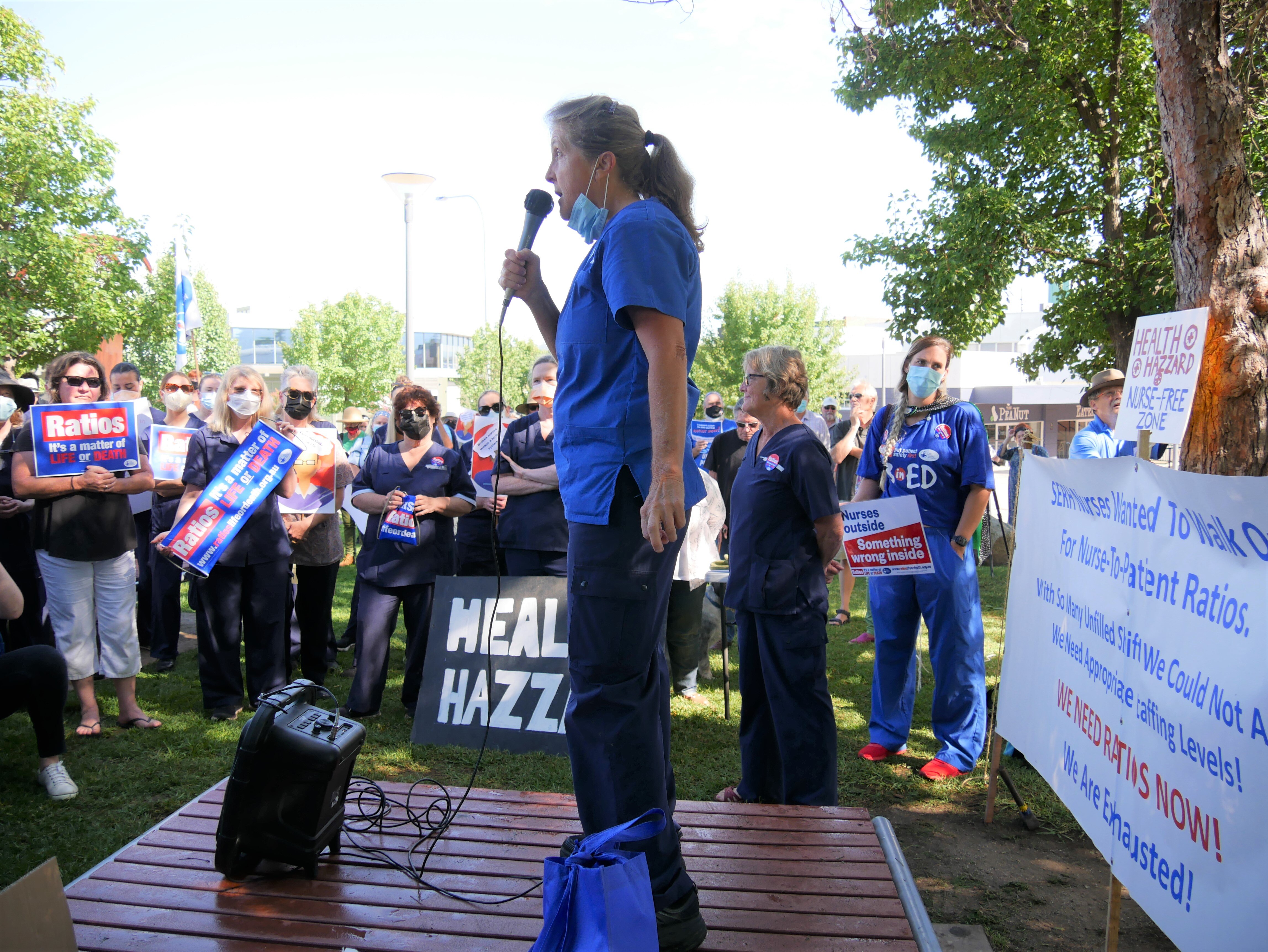 A woman addresses a crowd of nurses
