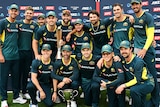 Australia's T20 team huddles around the Chappell-Hadlee Trophy