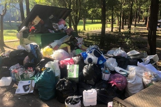 Piles of rubbish around a full skip at a campsite in south-west Victoria