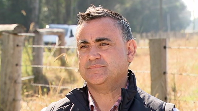 A man with grey hair in a field