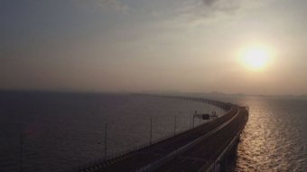 A wide shot of a bridge during sunrise.