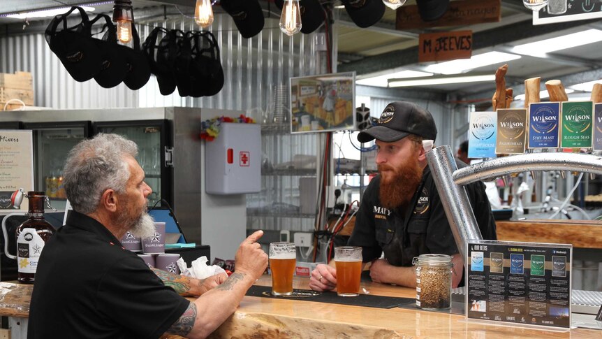 Harvester Joey Williams orders a quandong beer in a rural WA pub