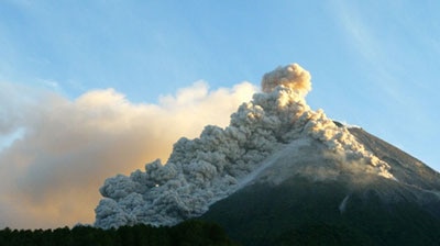 Mount Merapi volcano spews clouds of hot gas and ash rain as seen from Kaliadem village, near Indonesian city of Yogyakarta.