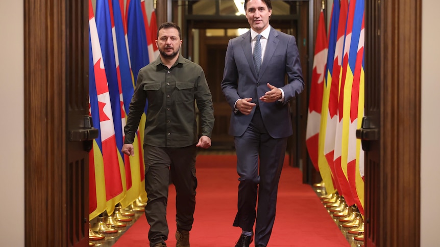 Ukrainian President Volodymyr Zelenskyy, left, and Prime Minister Justin Trudeau arrive at a signing ceremony.