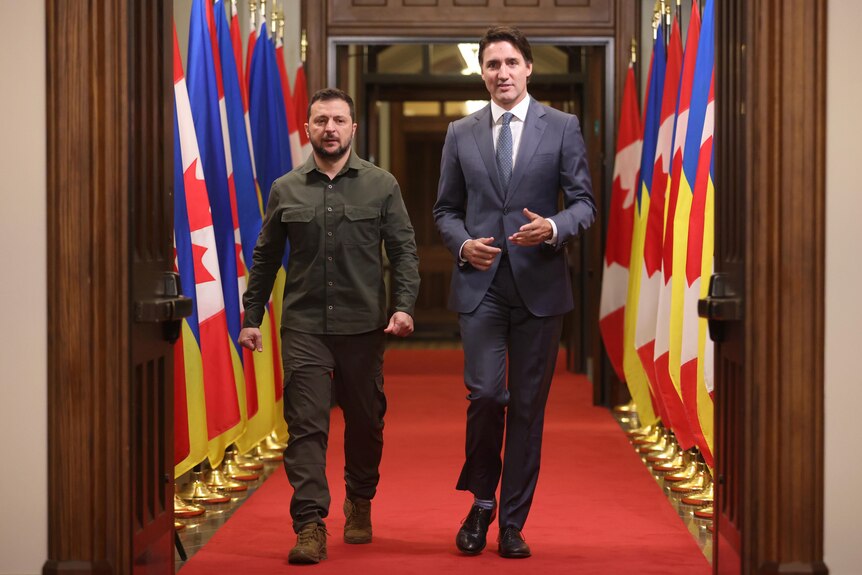 Ukrainian President Volodymyr Zelenskyy, left, and Prime Minister Justin Trudeau arrive at a signing ceremony.