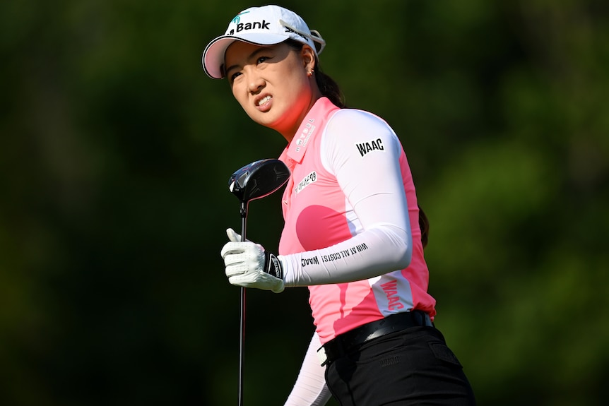 Minjee Lee grimaces while holding her driver and looking ahead 