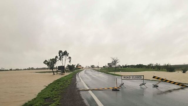 Floodwaters creep closer to the road at Julie Creek after heavy rainfall.