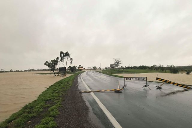 Floodwaters creep closer to the road at Julie Creek after heavy rainfall.