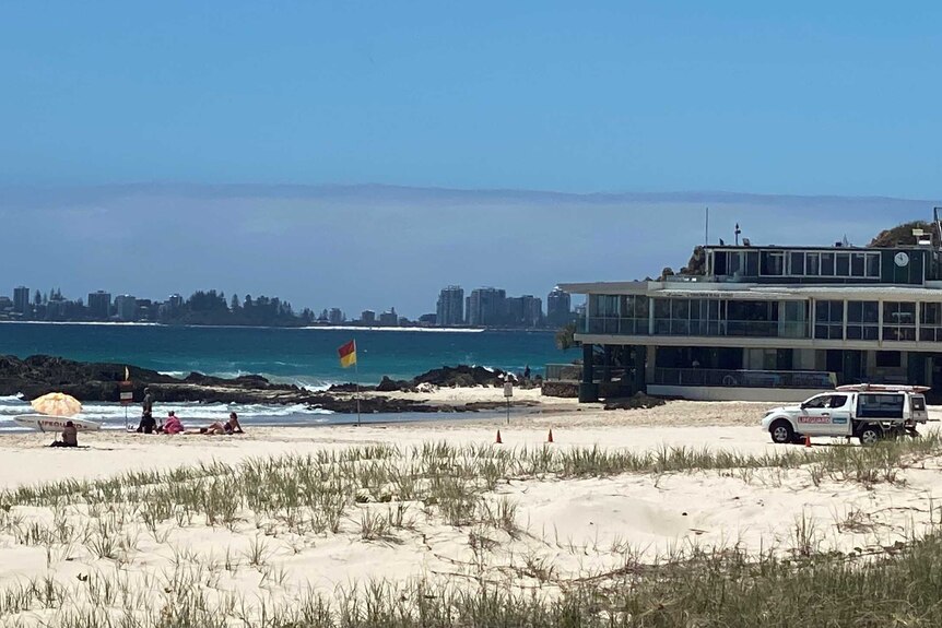 A beach scene with Gold Coast highrises in the background.