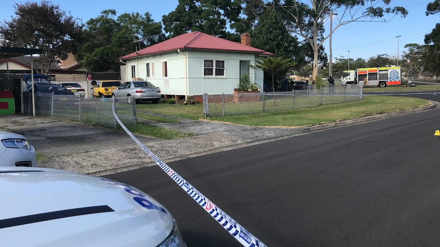 Police tape closing off residential street.