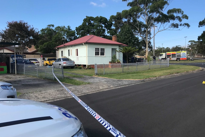 Police tape closing off residential street.