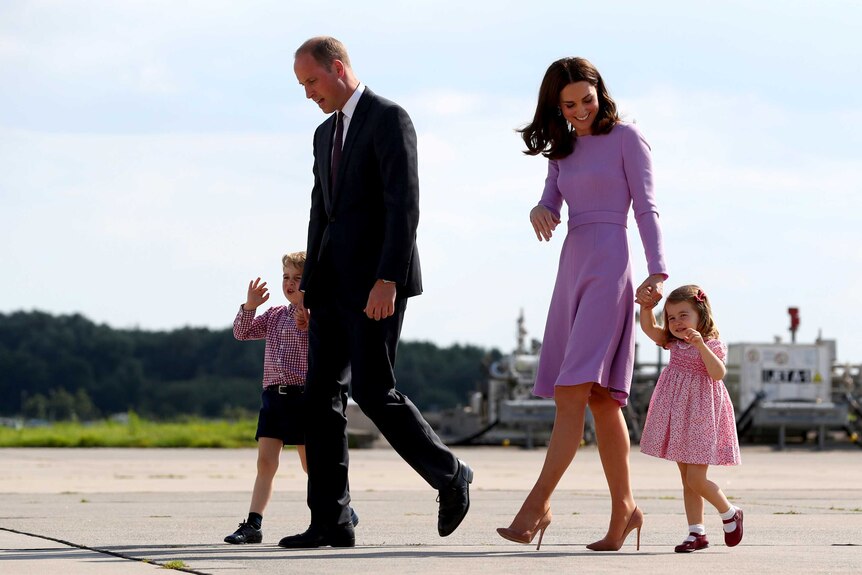 Prince William, Catherine, Prince George and Princess Charlotte walk along a tarmac together