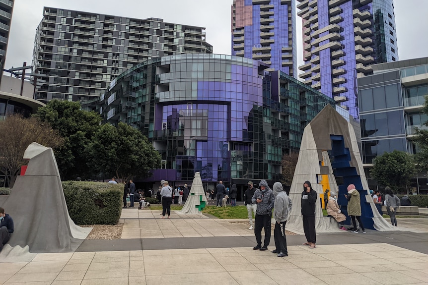 People standing outsdide buildings.