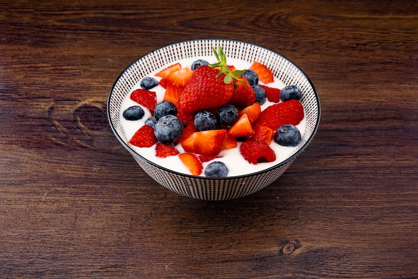 Fruit and yogurt in a bowl on a table