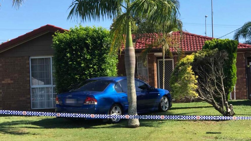 Police tape around a house at Browns Plains south of Brisbane where two men who allegedly shot a 10-year-old boy and his father.