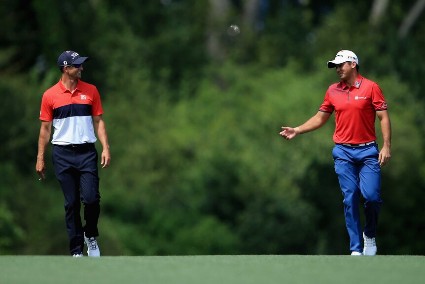 Adam Scott and Jason Day talk during the third round of the Masters