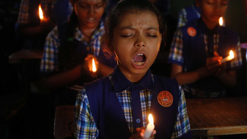 Indian child prays for trapped Thai boys