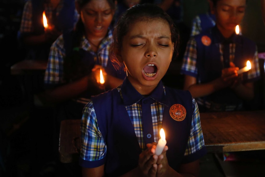 Indian child prays for trapped Thai boys