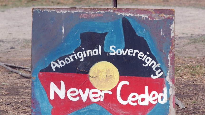 Placard reads Aboriginal Sovereignty Never Ceded