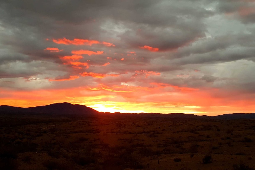 orange sunrise and grey clouds on mountains in South Australian landscape