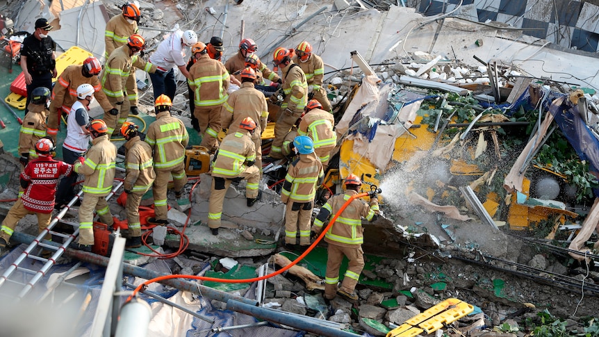 Firefighters search for survivors from a collapsed building in Gwangju, South Korea