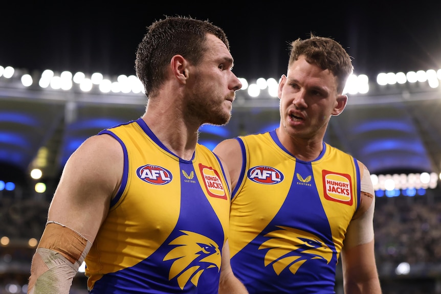 Luke Shuey and Jack Redden look serious as they talk to each other