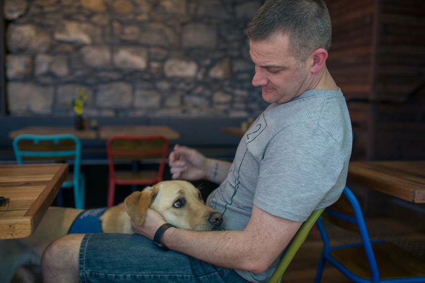 Victoria Police sergeant Rob Atkins with his assistance dog Jimmy