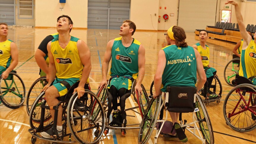 Young men in wheelchairs on basketball court