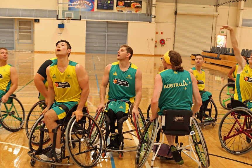 Young men in wheelchairs on basketball court