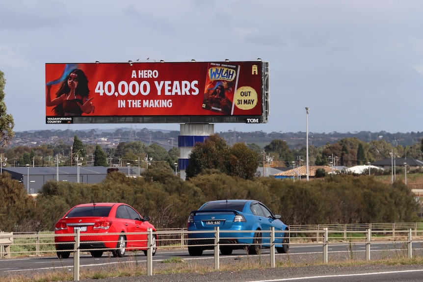A large billboard for a children's book on a highway reads 